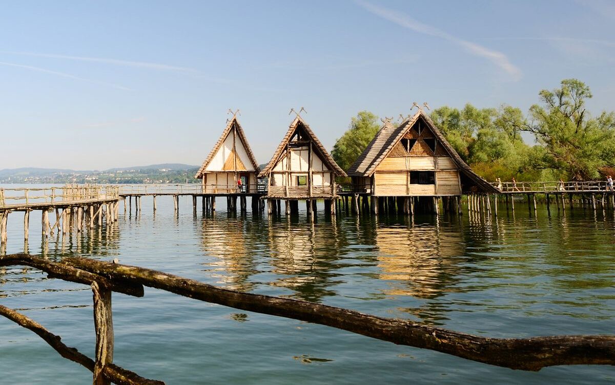 Three houses built on water, with a bridge connecting them